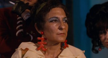 Movie still from “Easy Rider” (1969), directed by Dennis Hopper – A woman with red earrings is looking into the distance; Close Up shot, Over the shoulder angle