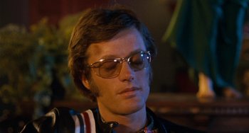 Movie still from “Easy Rider” (1969), directed by Dennis Hopper – A person wearing glasses; Close Up shot, Low angle