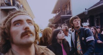 Movie still from “Easy Rider” (1969), directed by Dennis Hopper – A group of people standing in the street; Close Up shot, Low angle