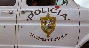 Movie still from “El Mariachi” (1992), directed by Robert Rodriguez – The side of a police truck; Extreme Close Up shot, Low angle