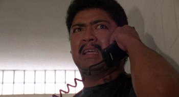Movie still from “El Mariachi” (1992), directed by Robert Rodriguez – A person talking on a phone; Close Up shot, Low angle