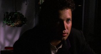 Movie still from “El Mariachi” (1992), directed by Robert Rodriguez – A person wearing a suit and tie; Close Up shot, Low angle