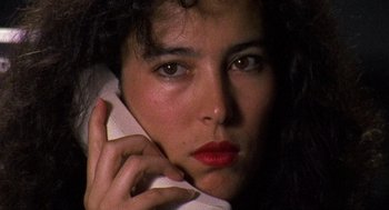 Movie still from “El Mariachi” (1992), directed by Robert Rodriguez – A person talking on a cell phone; Close Up shot, High angle