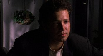 Movie still from “El Mariachi” (1992), directed by Robert Rodriguez – A person wearing a suit and tie; Close Up shot, Low angle