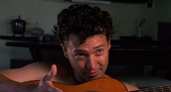 Movie still from “El Mariachi” (1992), directed by Robert Rodriguez – A person holding a guitar; Close Up shot, Low angle