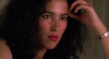 Movie still from “El Mariachi” (1992), directed by Robert Rodriguez – A person with long curly black hair; Close Up shot, High angle