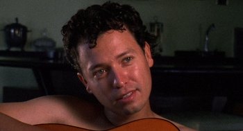 Movie still from “El Mariachi” (1992), directed by Robert Rodriguez – A person holding a guitar; Close Up shot, Low angle