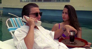 Movie still from “El Mariachi” (1992), directed by Robert Rodriguez – A man and a woman sitting next to each other; Medium shot, Low angle