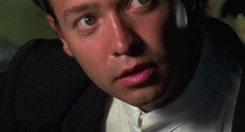 Movie still from “El Mariachi” (1992), directed by Robert Rodriguez – A man in a white shirt and a black jacket; Extreme Close Up shot, Low angle
