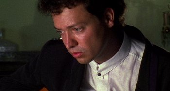 Movie still from “El Mariachi” (1992), directed by Robert Rodriguez – A person wearing a white shirt; Close Up shot, Low angle