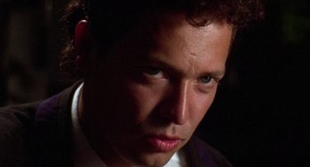 Movie still from “El Mariachi” (1992), directed by Robert Rodriguez – A person wearing a suit and tie; Close Up shot, Low angle