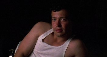 Movie still from “El Mariachi” (1992), directed by Robert Rodriguez – A person wearing a white shirt; Close Up shot, Low angle