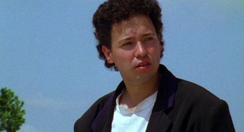 Movie still from “El Mariachi” (1992), directed by Robert Rodriguez – A person wearing a suit and tie; Close Up shot, Low angle