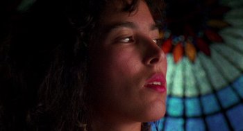 Movie still from “El Mariachi” (1992), directed by Robert Rodriguez – A woman's face in front of a stained glass window; Close Up shot, Low angle