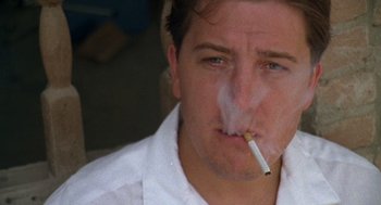 Movie still from “El Mariachi” (1992), directed by Robert Rodriguez – A person smoking a cigarette; Close Up shot, Low angle