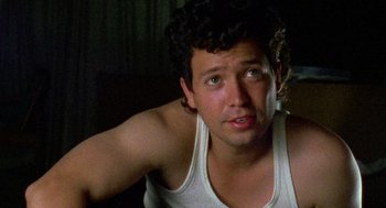 Movie still from “El Mariachi” (1992), directed by Robert Rodriguez – A person wearing a tank top; Close Up shot, Low angle