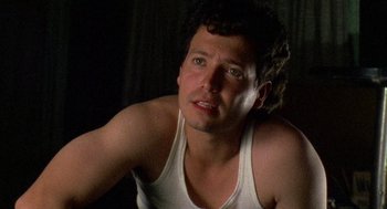 Movie still from “El Mariachi” (1992), directed by Robert Rodriguez – A person wearing a tank top; Close Up shot, Low angle