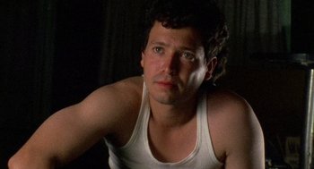 Movie still from “El Mariachi” (1992), directed by Robert Rodriguez – A person wearing a tank top; Close Up shot, Low angle