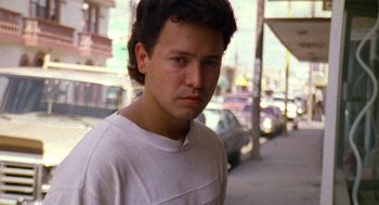 Movie still from “El Mariachi” (1992), directed by Robert Rodriguez – A young man standing on the side of the street; Close Up shot, Low angle