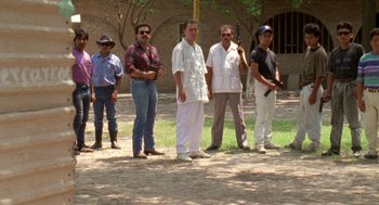 Movie still from “El Mariachi” (1992), directed by Robert Rodriguez – A group of men standing on a dirt field; Wide shot, Low angle