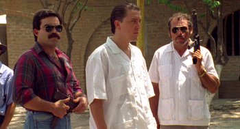 Movie still from “El Mariachi” (1992), directed by Robert Rodriguez – A group of men standing next to each other on a street; Medium shot, Low angle