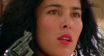 Movie still from “El Mariachi” (1992), directed by Robert Rodriguez – A woman's face with pink lipstick; Close Up shot, Low angle