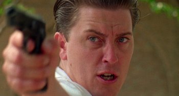 Movie still from “El Mariachi” (1992), directed by Robert Rodriguez – A person holding a gun; Close Up shot, Low angle