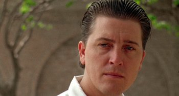 Movie still from “El Mariachi” (1992), directed by Robert Rodriguez – A person wearing a white shirt; Close Up shot, Low angle