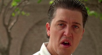 Movie still from “El Mariachi” (1992), directed by Robert Rodriguez – A person wearing a white shirt; Close Up shot, Low angle