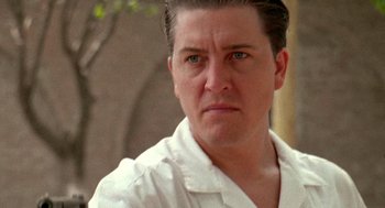 Movie still from “El Mariachi” (1992), directed by Robert Rodriguez – A person wearing a white shirt; Close Up shot, Low angle