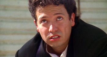Movie still from “El Mariachi” (1992), directed by Robert Rodriguez – A person wearing a suit and tie; Close Up shot, Low angle