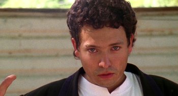 Movie still from “El Mariachi” (1992), directed by Robert Rodriguez – A person wearing a suit and tie; Close Up shot, Low angle