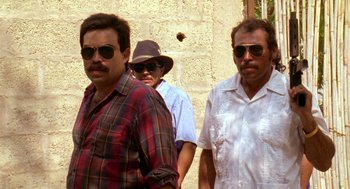 Movie still from “El Mariachi” (1992), directed by Robert Rodriguez – A group of men standing next to each other wearing sunglasses; Medium shot, Low angle