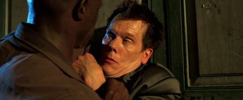 Movie still from “Elephant White” (2011), directed by Prachya Pinkaew – A person holding another person's face; Close Up shot, Overhead angle