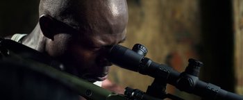 Movie still from “Elephant White” (2011), directed by Prachya Pinkaew – A person looking through a telescope; Extreme Close Up shot, Over the shoulder angle