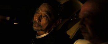 Movie still from “Elephant White” (2011), directed by Prachya Pinkaew – A person sitting in a car; Close Up shot, Over the shoulder angle