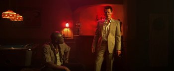 Movie still from “Elephant White” (2011), directed by Prachya Pinkaew – A man in a suit and tie standing next to another man in a suit and tie; Medium shot, Low angle