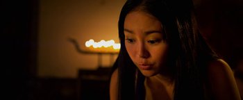 Movie still from “Elephant White” (2011), directed by Prachya Pinkaew – A young woman is looking down at her face; Close Up shot, High angle