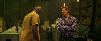 Movie still from “Elephant White” (2011), directed by Prachya Pinkaew – Two men are standing in a room talking to each other; Medium shot, Over the shoulder angle