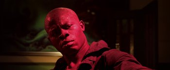 Movie still from “Elephant White” (2011), directed by Prachya Pinkaew – A person wearing a red shirt; Close Up shot, Low angle