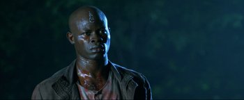 Movie still from “Elephant White” (2011), directed by Prachya Pinkaew – A person wearing a shirt and jacket; Close Up shot, Low angle