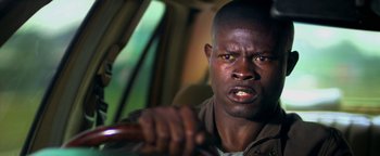 Movie still from “Elephant White” (2011), directed by Prachya Pinkaew – A person holding a steering wheel of a car; Close Up shot, Low angle