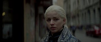 Movie still from “Ema” (2019), directed by Pablo Larraín – A woman with blonde hair is standing in a street; Close Up shot, Low angle