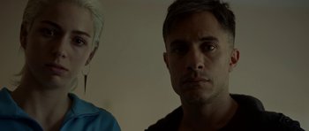 Movie still from “Ema” (2019), directed by Pablo Larraín – A man and a woman standing next to each other in a room; Close Up shot, Low angle