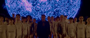 Movie still from “Ema” (2019), directed by Pablo Larraín – A man standing in front of a group of women; Wide shot, Low angle