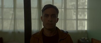 Movie still from “Ema” (2019), directed by Pablo Larraín – A person wearing a brown jacket; Close Up shot, Low angle