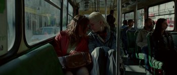 Movie still from “Ema” (2019), directed by Pablo Larraín – Two young women are sitting on a public transit bus; Close Up shot, High angle