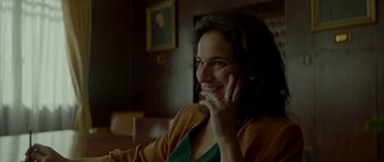Movie still from “Ema” (2019), directed by Pablo Larraín – A woman sitting in a chair talking on a phone; Close Up shot, Low angle