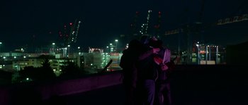 Movie still from “Ema” (2019), directed by Pablo Larraín – A group of people standing next to each other on top of a building; Wide shot, Low angle