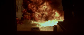 Movie still from “Ema” (2019), directed by Pablo Larraín – A bus on a street with a large fire in the background; Extreme Wide shot, Low angle